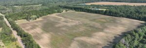Mid-altitude aerial showing field with paved 18th Street West access road and distant lake, Necedah, WI (LOT 2)
