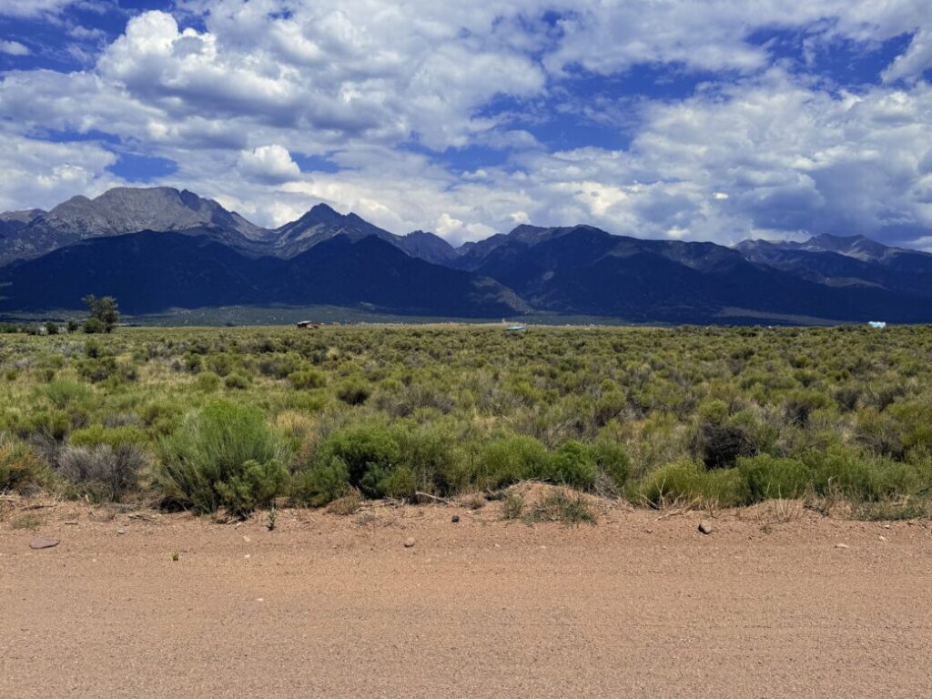 Ground-level view across native sagebrush toward the full Sangre de Cristo mountain range, Crestone area, APN 460324300062