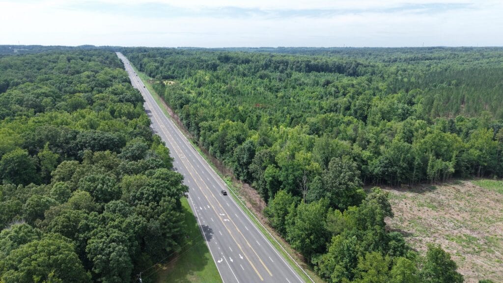 Aerial view of NC 14 highway with wooded property frontage, Reidsville NC — parcels 181763/181764/180667