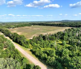 9.45-acre lot for sale in Necedah, Juneau County, Wisconsin — aerial view of the property and surrounding countryside
