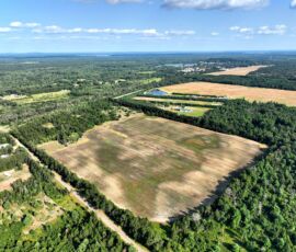 18.92-acre double lot for sale in Necedah, Juneau County, Wisconsin — aerial view of the property and surrounding countryside