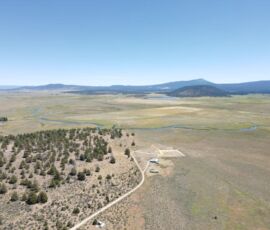 Aerial over the property looking out to the Sprague River winding through open meadows with mountains beyond - Chiloquin, OR (R349714)