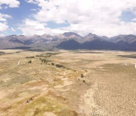 Aerial drone view of the San Luis Valley floor with the Sangre de Cristo range spanning the full background, Crestone, CO, APN 460324300062