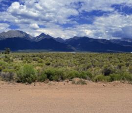 Ground-level view across native sagebrush toward the full Sangre de Cristo mountain range, Crestone area, APN 460324300062