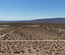 Aerial overview of the 2.21-acre lot with the Hualapai Mountain range prominent across the background, Yucca AZ — APN 245-21-102