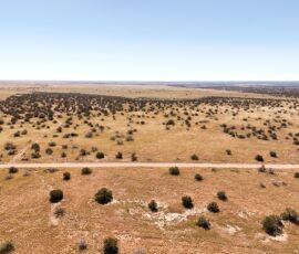 Aerial view showing the parcel, neighboring community, and surrounding open desert, Navajo County AZ — parcel 111-22-195